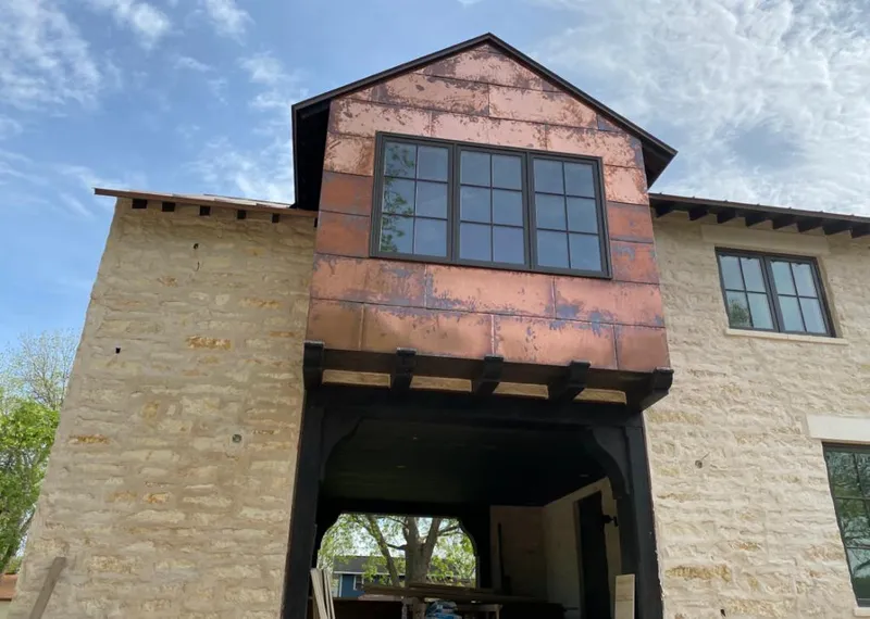 Copper metal panel facade on a stone building for Metal Roof Coating in Bolivar